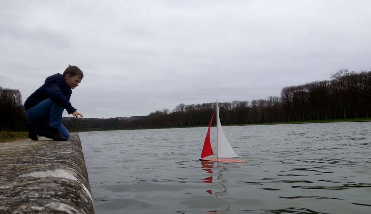 Wooden model boat sailing on the ornamental lake of Luxembourg